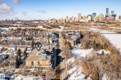 The property features a brick exterior and a gabled roof - 307 9750 94 Street, Edmonton, AB - Outdoor With View