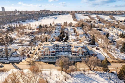 This property is situated in a community featuring snow-covered landscapes, residential buildings, and a clear view of distant structures - 307 9750 94 Street, Edmonton, AB - Outdoor With View