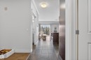 The property features tiled flooring in the entryway, leading into a living area with hardwood floors and a balcony - 307 9750 94 Street, Edmonton, AB  - Indoor Photo Showing Other Room 