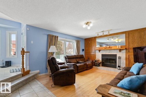 Family Room With Patio Doors To Deck. - 12824 157 Avenue, Edmonton, AB - Indoor Photo Showing Living Room With Fireplace