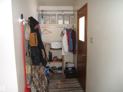 The entry area features a wood door with a window insert and a textured floor mat - 