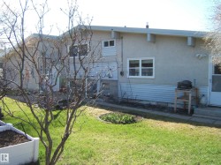 Exterior featuring a stucco and siding finish, white trim windows, and a side entrance door - 