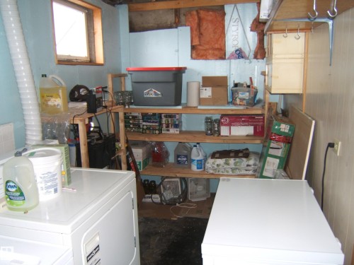 Utility area featuring a window, built-in shelving, and laundry appliances - 4702 52 Avenue, Two Hills, AB - Indoor