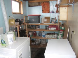 Utility area featuring a window, built-in shelving, and laundry appliances - 