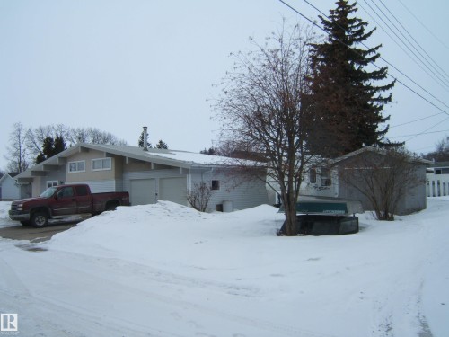 The property features a two-car garage, a sloped roofline, and an exterior with two distinct siding types - 4702 52 Avenue, Two Hills, AB - Outdoor