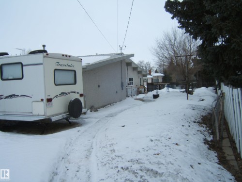 The property features an exterior with a neutral-toned facade and a white fence, offering a defined perimeter - 4702 52 Avenue, Two Hills, AB - Outdoor