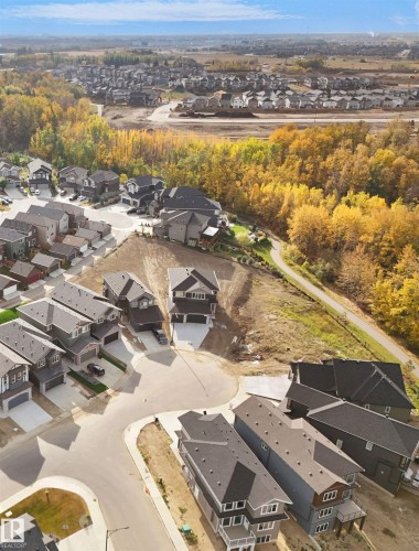 Aerial view showcasing a residential area with varied home styles and surrounding natural landscapes - 1127 Gyrfalcon Crescent, Edmonton, AB - Outdoor With View