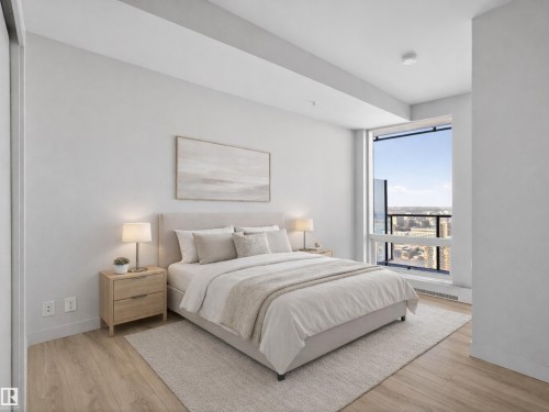 This room features light wood-style flooring and light-coloured walls, creating a bright and airy atmosphere. Virtually Staged for Illustrative Purposes - 2612 10360 102 Street, Edmonton, AB - Indoor Photo Showing Bedroom