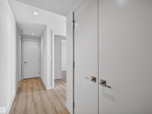 Hallway featuring light wood flooring and white walls. - 2612 10360 102 Street, Edmonton, AB - Indoor Photo Showing Other Room