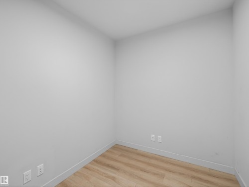 This room features light-colored walls and wood-style flooring - 2612 10360 102 Street, Edmonton, AB - Indoor Photo Showing Other Room