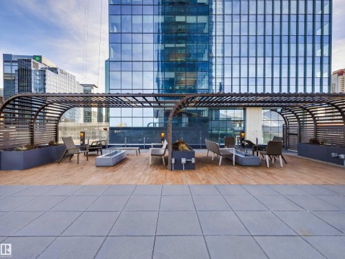 Exclusive Residents Area. Terrace features a slatted pergola structure, wood-look flooring, and a paved area - 2612 10360 102 Street, Edmonton, AB - Outdoor