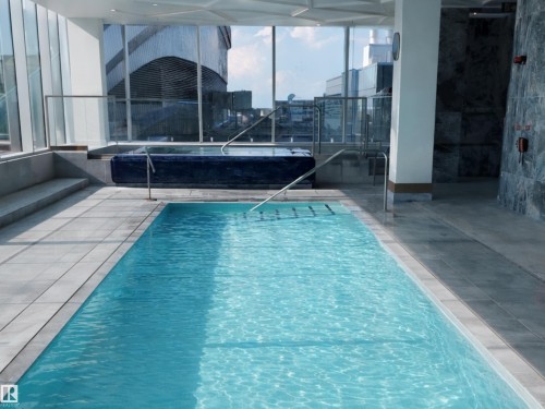 Indoor swimming pool and hot tub area with expansive windows providing views of the surrounding area - 2612 10360 102 Street, Edmonton, AB -  Photo Showing Other Room With In Ground Pool