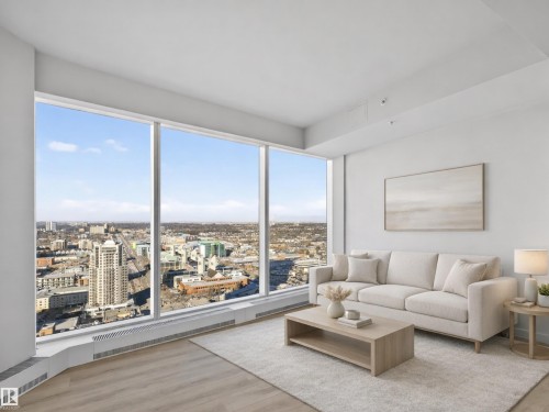Living area featuring expansive windows with city views, and light-toned flooring. Virtually Staged for Illustrative Purposes - 2612 10360 102 Street, Edmonton, AB - Indoor Photo Showing Living Room