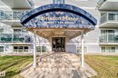 The property features a welcoming entrance with a covered awning, concrete steps, and a glass-paneled entry door - 403 10624 123 Street, Edmonton, AB  - Outdoor With Exterior 