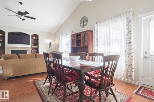 5601 Rue Eaglemont, Beaumont, AB - Indoor Photo Showing Dining Room With Fireplace