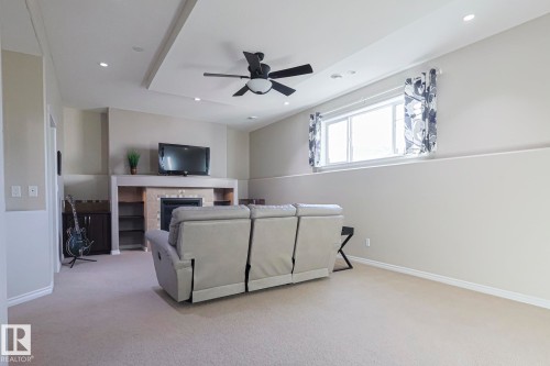 5601 Rue Eaglemont, Beaumont, AB - Indoor Photo Showing Other Room With Fireplace