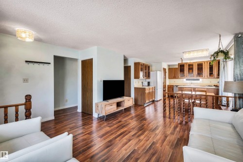 Open concept living area featuring wood floors throughout, a kitchen with wood cabinetry, and a dining area - 18923 86A Avenue, Edmonton, AB - Indoor Photo Showing Living Room