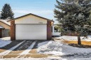 The property features a brick exterior with a prominent white garage door and a paved driveway - 18923 86A Avenue, Edmonton, AB  - Outdoor 