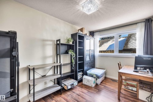 This room features rich wood flooring, a window with curtains, and a ceiling light fixture - 18923 86A Avenue, Edmonton, AB - Indoor Photo Showing Office