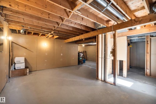 The property features an unfinished basement with a concrete floor, exposed wooden ceiling beams, and partial wall framing - 18923 86A Avenue, Edmonton, AB - Indoor Photo Showing Basement