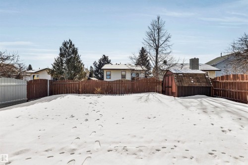 The property features an extensive yard with a shed and a wooden fence - 18923 86A Avenue, Edmonton, AB - Outdoor
