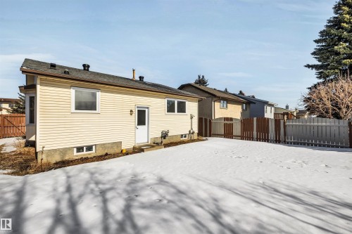 The property includes a fenced backyard with a snow-covered lawn - 18923 86A Avenue, Edmonton, AB - Outdoor With Exterior