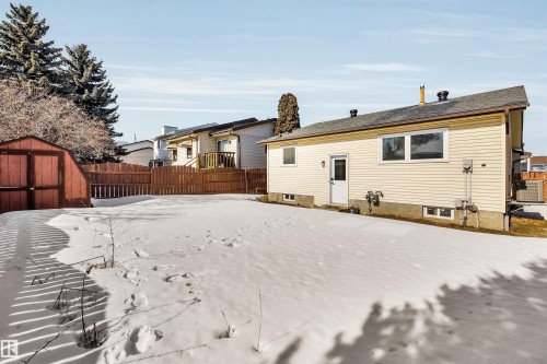 The property features a spacious rear yard with a storage shed and a wooden fence - 18923 86A Avenue, Edmonton, AB - Outdoor