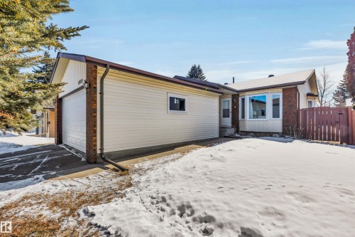 The property features a front yard with a driveway, an attached garage, and a bay window - 18923 86A Avenue, Edmonton, AB - Outdoor