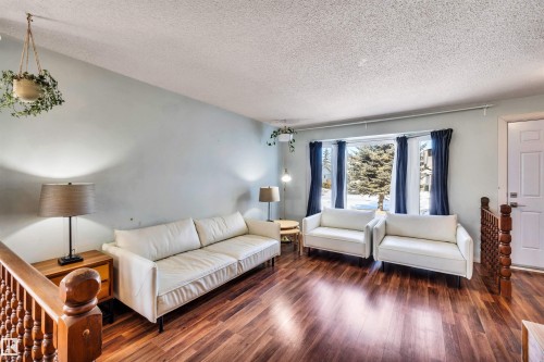 Living space featuring rich hardwood flooring and a large bay window, providing natural light - 18923 86A Avenue, Edmonton, AB - Indoor Photo Showing Living Room