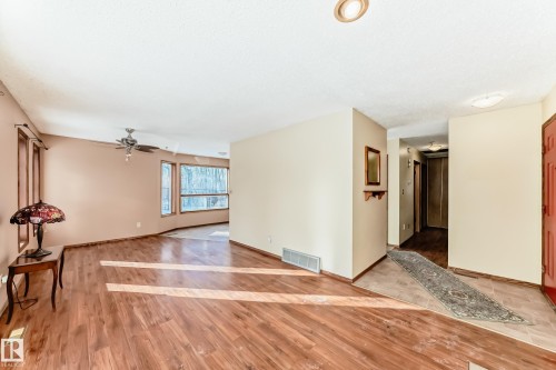 The property features wood-style flooring and a light-colored wall paint - 100 23016 Twp Rd 504, Rural Leduc County, AB - Indoor Photo Showing Other Room