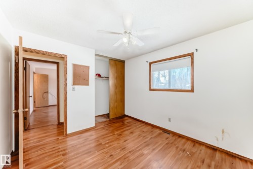 This room features hardwood flooring, a window providing natural light, and a ceiling fan - 100 23016 Twp Rd 504, Rural Leduc County, AB - Indoor Photo Showing Other Room