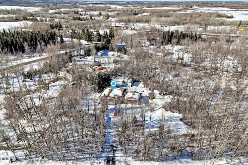 Aerial view of the property, set amongst a landscape with extensive trees and snow-covered ground - 100 23016 Twp Rd 504, Rural Leduc County, AB - Outdoor With View