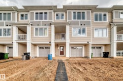 Contemporary multi-level townhome featuring a mix of horizontal siding and vertical accents - 