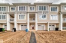 Contemporary multi-level townhome featuring a mix of horizontal siding and vertical accents - 20415 16 Avenue, Edmonton, AB 