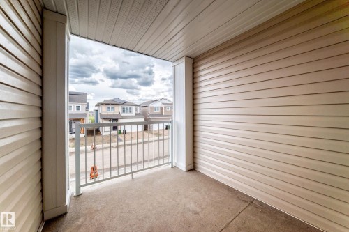 Balcony with concrete flooring and white metal railing - 20415 16 Avenue, Edmonton, AB 
