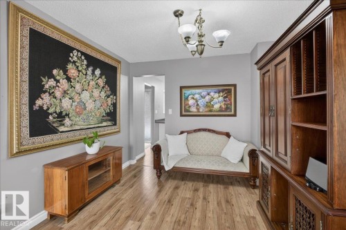 This space features wood-style flooring and light grey walls - 3240 130A Avenue, Edmonton, AB - Indoor