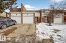 The property features a brick exterior, an attached garage with a white door, and a private balcony with a white railing - 3240 130A Avenue, Edmonton, AB  - Outdoor With Balcony 