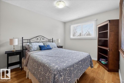 This room features hardwood flooring, a window with blinds, and light-colored walls - 3240 130A Avenue, Edmonton, AB - Indoor Photo Showing Bedroom
