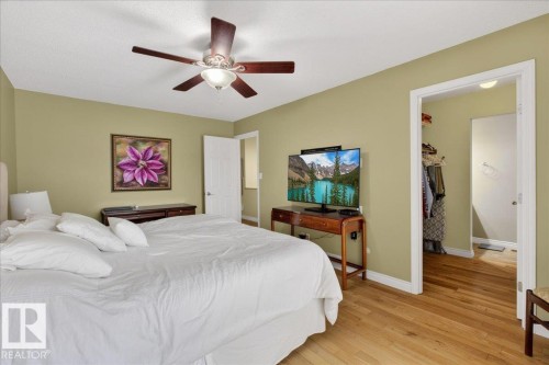 This room features light green walls and hardwood floors - 3240 130A Avenue, Edmonton, AB - Indoor Photo Showing Bedroom