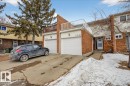 The property features a brick exterior with white garage doors and a white front entrance door - 3240 130A Avenue, Edmonton, AB  - Outdoor 