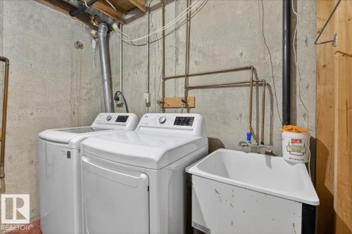 Laundry area featuring a washer, dryer, and utility sink - 3240 130A Avenue, Edmonton, AB - Indoor Photo Showing Laundry Room