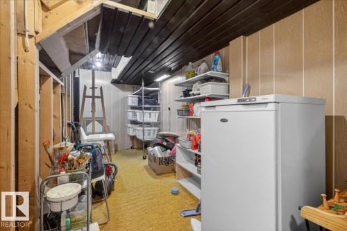 The property features exposed wooden beams, vertical wall paneling, and a carpeted floor - 3240 130A Avenue, Edmonton, AB - Indoor