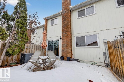 The property features a private backyard with a patio area and a sliding glass door providing direct access to the interior - 3240 130A Avenue, Edmonton, AB - Outdoor With Exterior