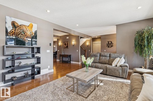 Living area featuring hardwood flooring, a textured area rug, and recessed lighting - 11409 63 Street Nw, Edmonton, AB - Indoor Photo Showing Living Room