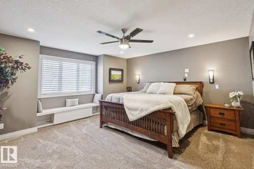 This room features a window with blinds and a built-in bench, recessed lighting, and a ceiling fan - 11409 63 Street Nw, Edmonton, AB - Indoor Photo Showing Bedroom