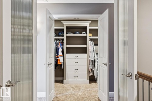 Custom closet with built-in shelving, drawers, and hanging rods - 11409 63 Street Nw, Edmonton, AB - Indoor Photo Showing Other Room