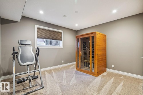 This versatile room features neutral-toned walls, recessed lighting, and soft carpet flooring - 11409 63 Street Nw, Edmonton, AB - Indoor