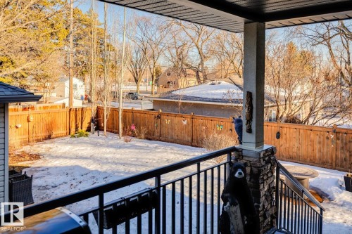 The property features a fenced yard with a combination of mature and younger trees - 11409 63 Street Nw, Edmonton, AB - Outdoor