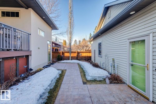 Exterior view featuring a walkway and two structures with contrasting siding materials - 11409 63 Street Nw, Edmonton, AB - Outdoor With Exterior