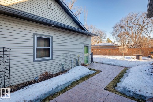 The property features light-colored horizontal siding and a window with gray trim - 11409 63 Street Nw, Edmonton, AB - Outdoor